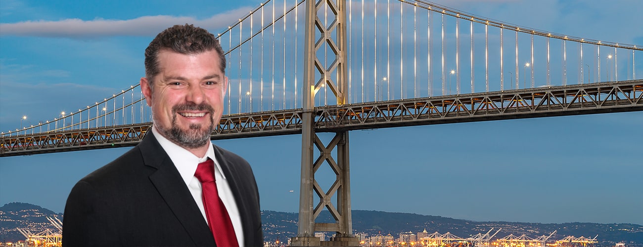 Spencer C. Young picture over background of San Francisco-Oakland Bay Bridge